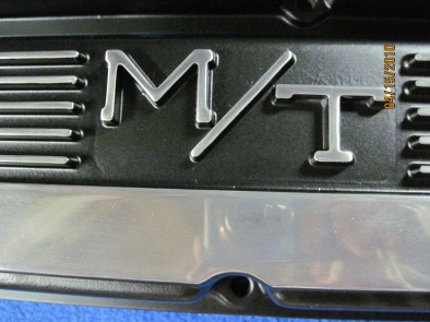 Close up shop photo of Mickey Thompson Mopar valve covers in Silk Satin Black with polished fins/logos