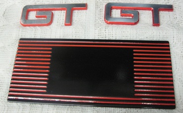 Cobra fuse box cover in Flame Red, Ink Black and Clear Vision; one GT emblem in Flame Red and the other in Lollypop Red